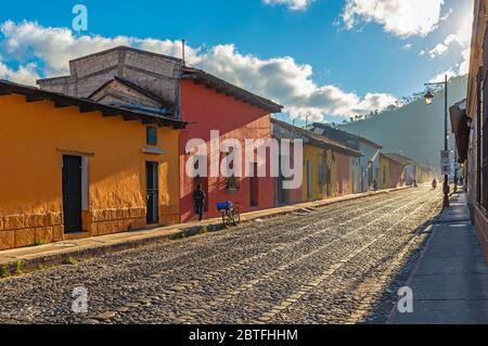 City life at sunrise in the colorful colonial style streets of Antigua, Guatemala. Stock Photo