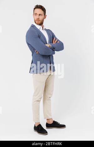 Image of serious young man wearing jacket posing and looking aside isolated over white background Stock Photo