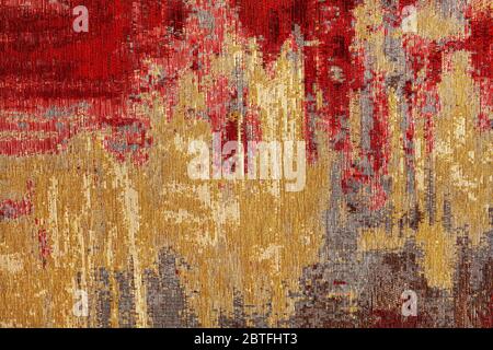 Texture of oriental red-gold carpet tapestry with abstract pattern, closeup. Stock Photo