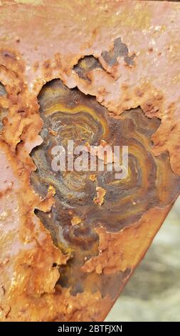 Rusty metal surface with flaking layers and marbled patterns. Corrosion of metal texture closeup Stock Photo