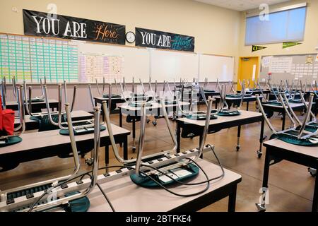Empty classroom in an American high school; closed for distance education during Coronavirus pandemic; social distancing and education. Stock Photo