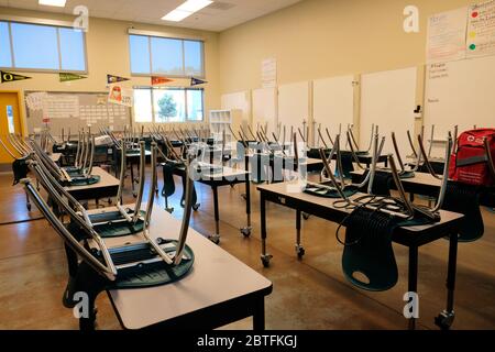 Empty classroom in an American high school; closed for distance education during Coronavirus pandemic; social distancing and education. Stock Photo