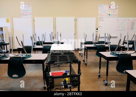 Empty classroom in an American high school; closed for distance education during Coronavirus pandemic; social distancing and education. Stock Photo