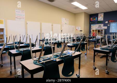 Empty classroom in an American high school; closed for distance education during Coronavirus pandemic; social distancing and education. Stock Photo
