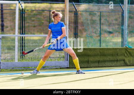 Field hockey player performing corner penalty shot. Stock Photo