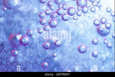 water drops on purple background. colored abstract background. Stock Photo