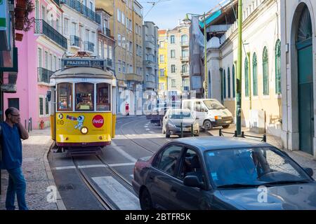 LISBON, PORTUGAL - SEPT 18, 2018: Famous old-fashioned tram 28 on a narrow Lisbon street, Portugal Stock Photo
