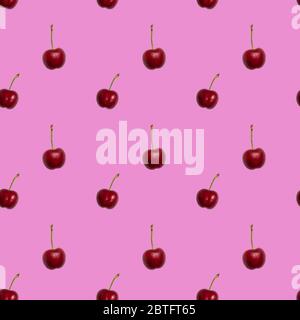Ripe red cherry seamless pattern on pink background Stock Photo