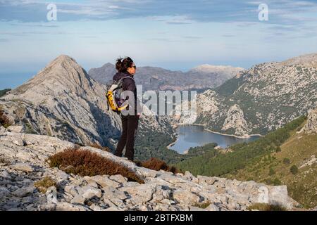 trekker in front of the Gorg Blau reservoir, Escorca, Mallorca, Balearic Islands, Spain. Stock Photo