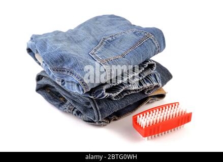 Jeans cleaning concept with red brush Stock Photo