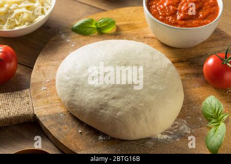 Homemade PIzza Dough and Ingredients with Basil Stock Photo