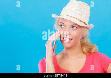 International calls, calling friends and family abroad, modern technology concept. Tourist woman with sun hat talking on phone Stock Photo
