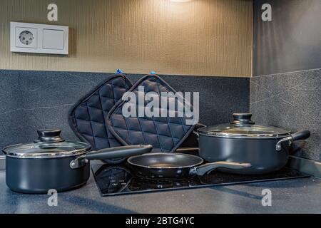 empty pan on stove with stands on table closeup modern kitchenware Stock Photo