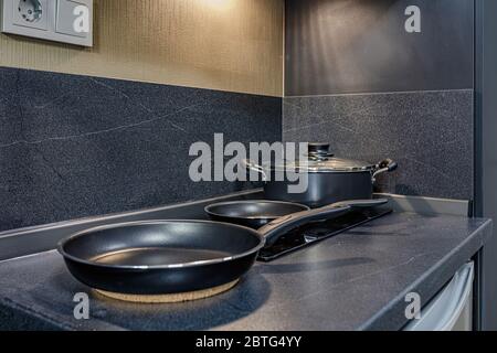 empty pan on stove with stands on table closeup modern kitchenware Stock Photo