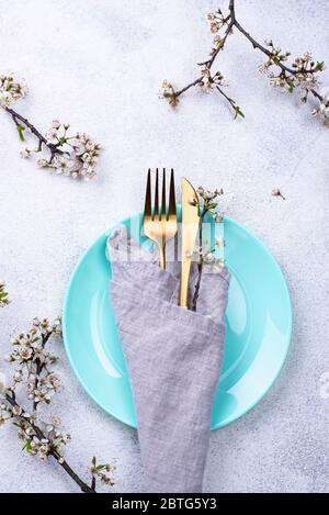 Spring table setting with blooming branch Stock Photo