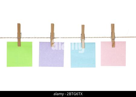 Colored reminder notes on string line with pegs Stock Photo