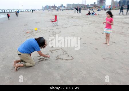 Brooklyn, NY, USA. 25th May, 2020. New Yorkers and lovers of Coney Island visit the Coney Island Boardwalk to celebrate Memorial Day, the unofficial start of the summer, where free facial masks where distributed by members of clergy and the NYPD, including NYPD Chief Shcoll on May 25, 2020 in Brooklyn, New York. Credit: Mpi43/Media Punch/Alamy Live News Stock Photo