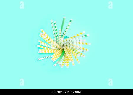 Paper Cocktail tubes in a grass on the blue background. Copy space. minimalism Stock Photo