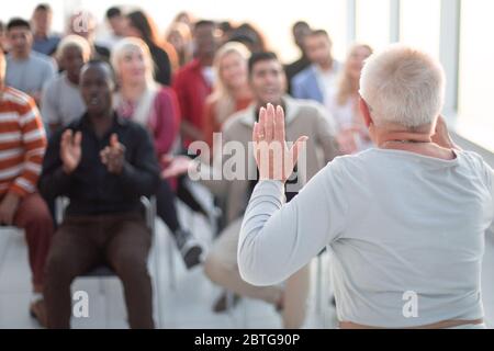 successful older woman talking about something at a business training Stock Photo