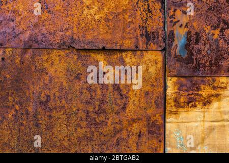 Rusted flat composite nailed metal sheets surface background and texture. Stock Photo
