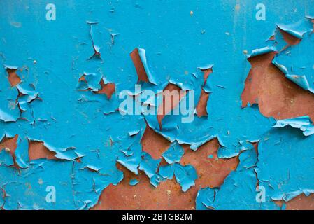 Peeling blue paint on rusty metal wall. Close up pattern of rustic grunge material Stock Photo