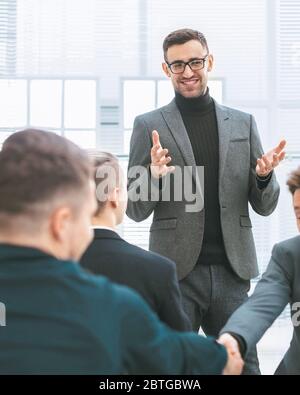 smiling employees shaking hands during a working meeting Stock Photo