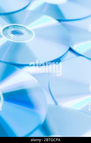 Stack of CD or DVD in blue tone as background. Soft focus. Stock Photo