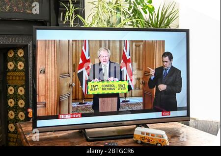 Prime Minister Boris Johnson giving a televised press conference from Downing Street in regard to Covid-19 with 'stay alert, save lives' slogan.