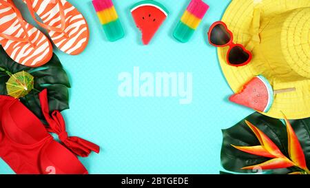 Summer vacation resort theme flat lay with sunhat, ice creams, swim suit, sunglasses, tropical leaves and flowers in bright colors on blue background. Stock Photo