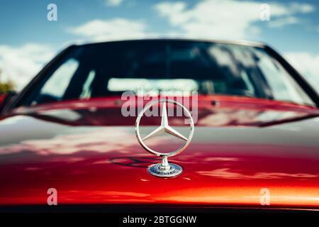 Russia, Voronezh - Circa 2019 : Mercedes Benz sign logo on hood of car, close up. Mercedes-Benz is trademark and company manufacturer of premium cars, trucks, buses and other vehicles. Stock Photo