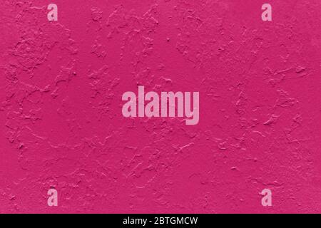seamless texture of flat thick painted boudoir red surface under direct sunlight - new paint over fragments of old peeled one Stock Photo