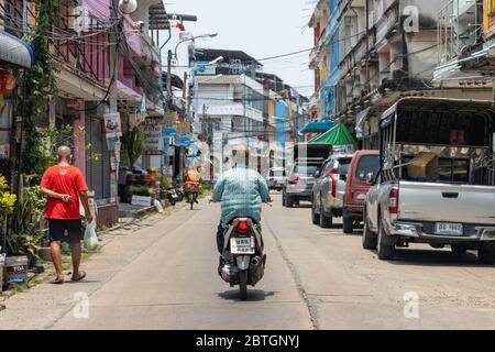 SAMUT PRAKAN, THAILAND, APR 27 2020, Small traffic on a local road on Sunday at noon Stock Photo