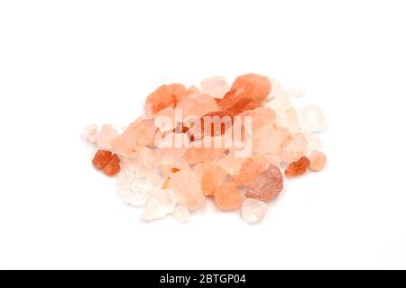 Pile of Himalayan pink salt salt from Punjab region, Pakistan heap on white isolated background in side view, close up macro concept. Himalayan pink r Stock Photo