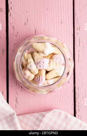 Jelly candy shape ice cream. Gummy bonbons in jar on pink table. Top view. Stock Photo