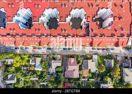 aerial top down view of roofs of apartment buildings and private houses in city residential area Stock Photo