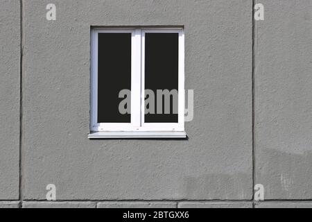 A double-hung window in the concrete slab of the new house. The texture of the concrete. Stock Photo