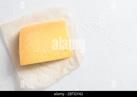 Parmesan cheese on white stone surface top view space for text. Stock Photo