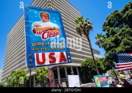 A protester holds a placard with an illustration of President Trump and text that says Mr. Clean wire tapped and still no dirt during a rally outside the Los Angeles City Hall to protest the Stay at Home Orders that were put in place due to the coronavirus pandemic. Los Angeles, California on May 25, 2020. Organizers called the Stay at Home Orders unconstitutional and called on Mayor Eric Garcetti and Governor Gavin Newsom to reopen the California economy. (Photo by Ronen Tivony/Sipa USA) *** Please Use Credit from Credit Field *** Credit: Sipa USA/Alamy Live News Stock Photo