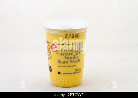 Alberton, South Africa - a container of Woolworths Food fresh custard with vanilla bean seeds isolated on a clear background Stock Photo