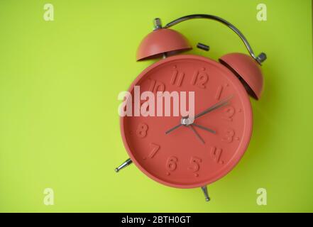Colorful clock isolated against yellow background Stock Photo