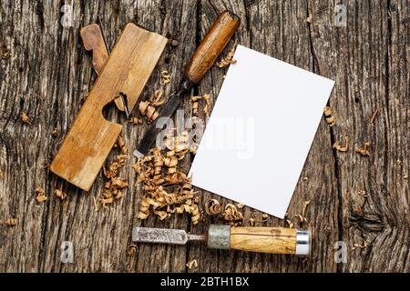 carpenter tools on dark rustic table with blank paper. Stock Photo