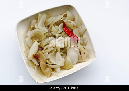 Salad of roasted yellow onions and dried hot red peppers with oil, salt and vinegar, Sofia, Bulgaria Stock Photo