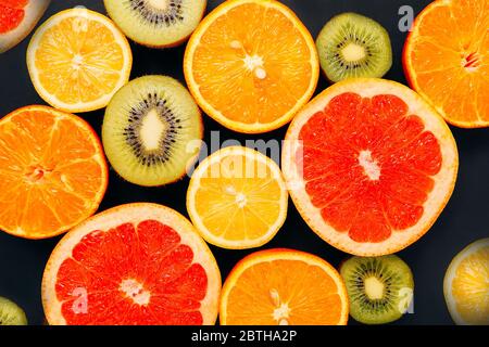 Citrus fruits pattern orange lemon grapefruit mandarin kiwi. Flatlay composition Stock Photo