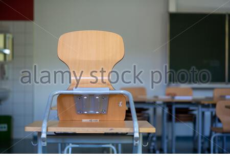 School furniture in a classroom in Germany as the Corona crisis rages on and many students remain at home Stock Photo