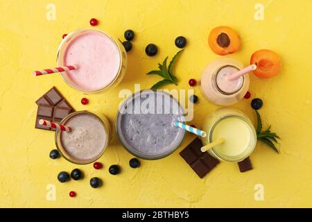 Delicious milkshakes on yellow background. Summer drink Stock Photo