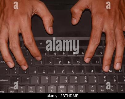 Working at home with laptop. male hands on keyboard. Stock Photo
