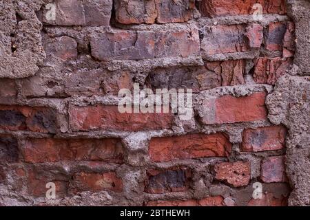 old brick of red clay old cement masonry close-up  Stock Photo