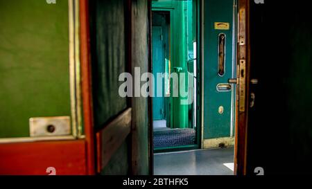Interior of old steam train car with long wooden corridor Stock Photo