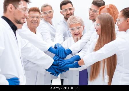 group of medical researchers making a tower out of their hands. Stock Photo