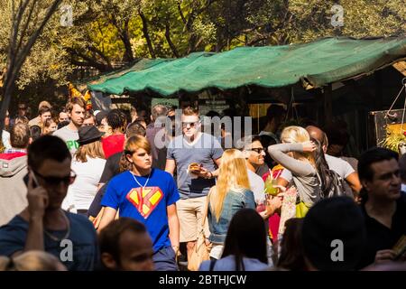 Johannesburg, South Africa - May 24, 2015: Crowds of diverse people at outdoor farmer's market walking through the take out food section Stock Photo